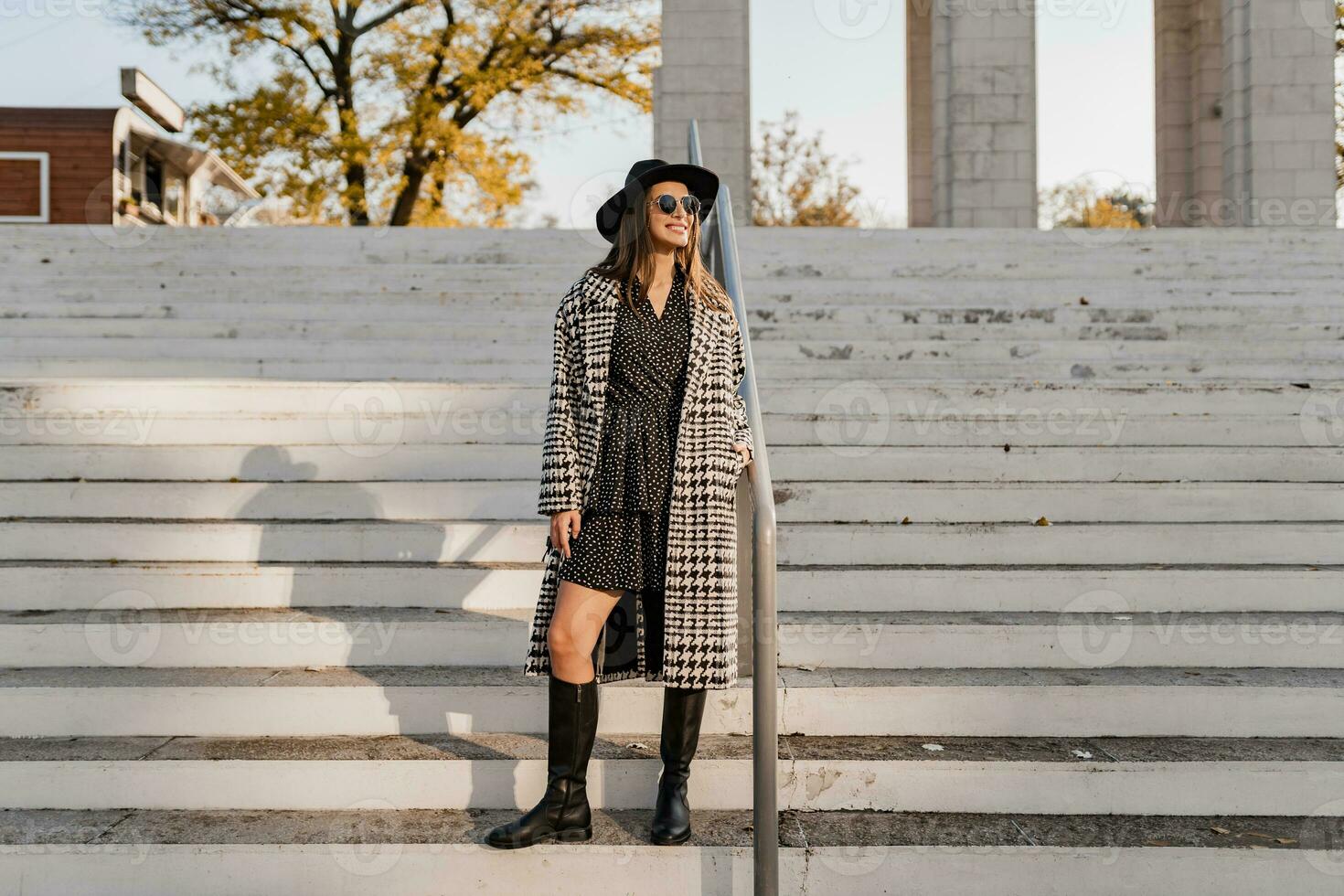 attractive young woman walking in autumn wearing coat photo