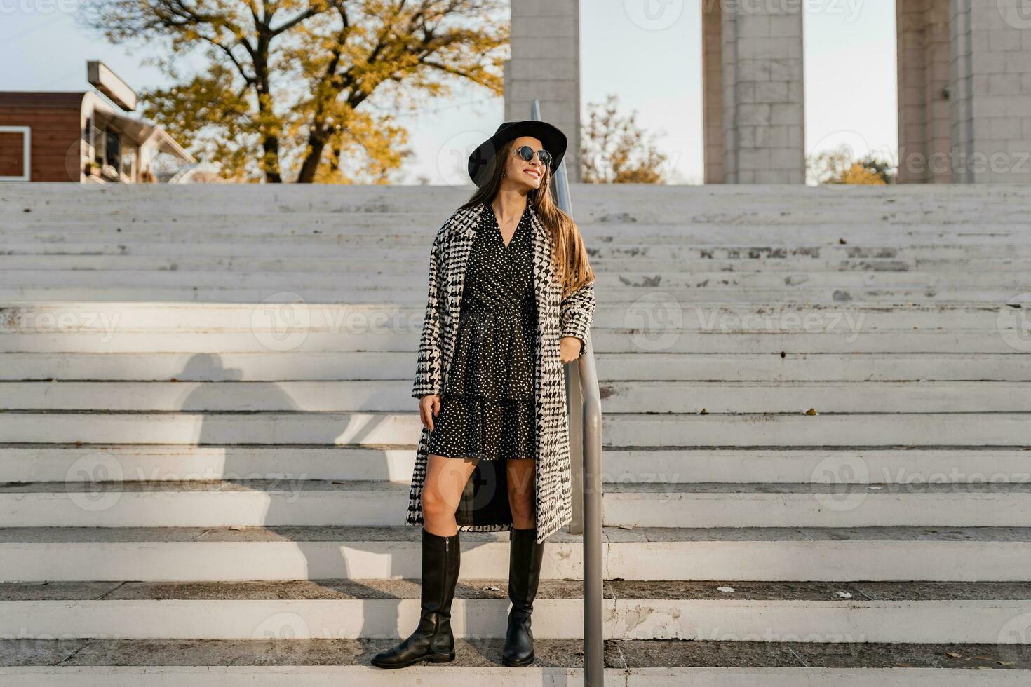 attractive young woman walking in autumn wearing coat photo