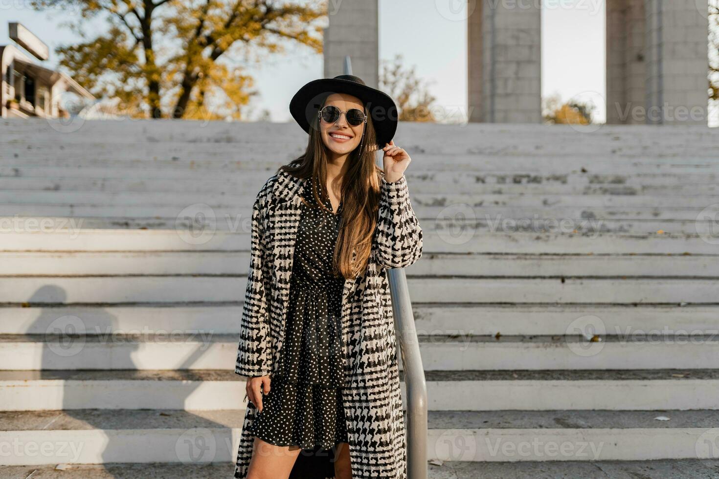attractive young woman walking in autumn wearing coat photo