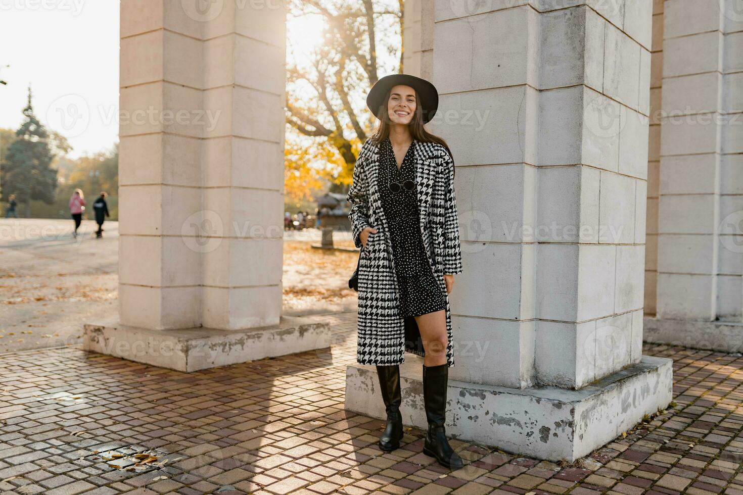 attractive young woman walking in autumn wearing coat photo