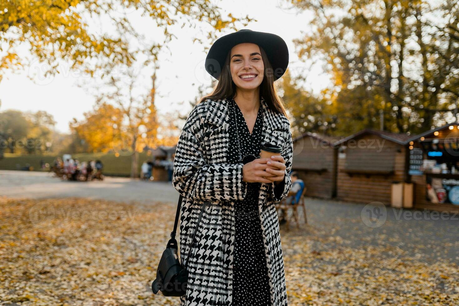 attractive young woman walking in autumn wearing coat photo