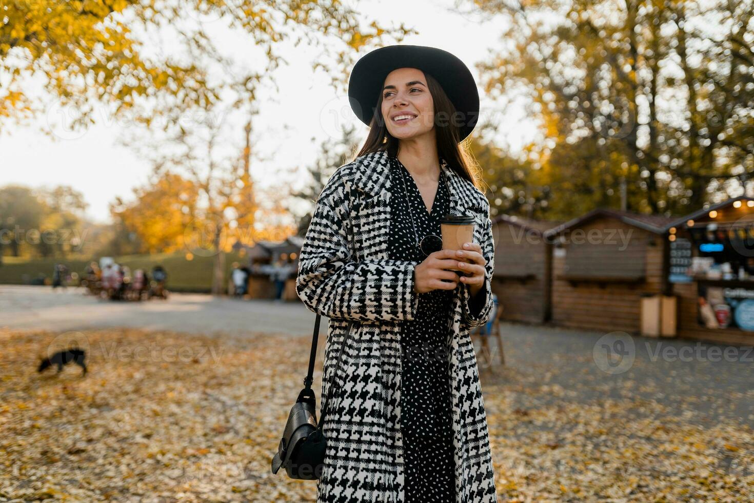attractive young woman walking in autumn wearing coat photo
