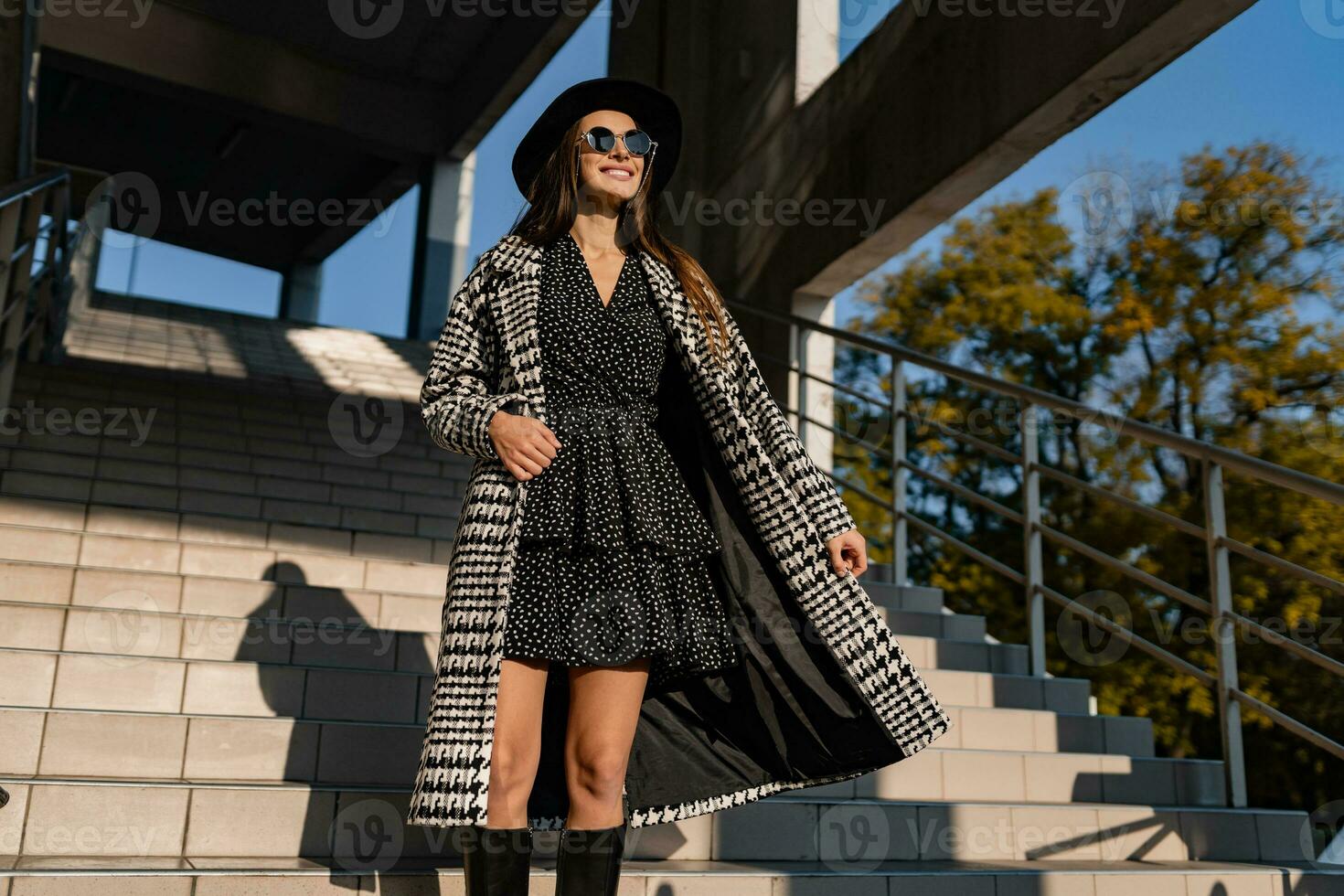 attractive young woman walking in autumn wearing coat photo