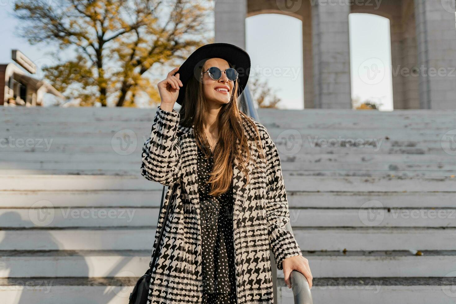 attractive young woman walking in autumn wearing coat photo
