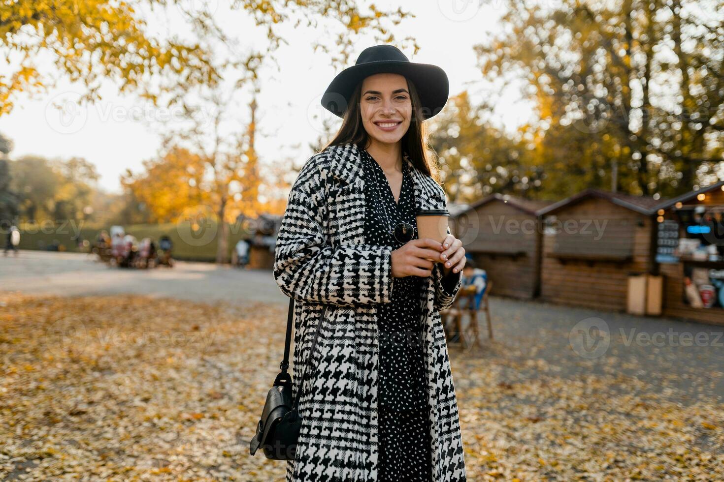 attractive young woman walking in autumn wearing coat photo