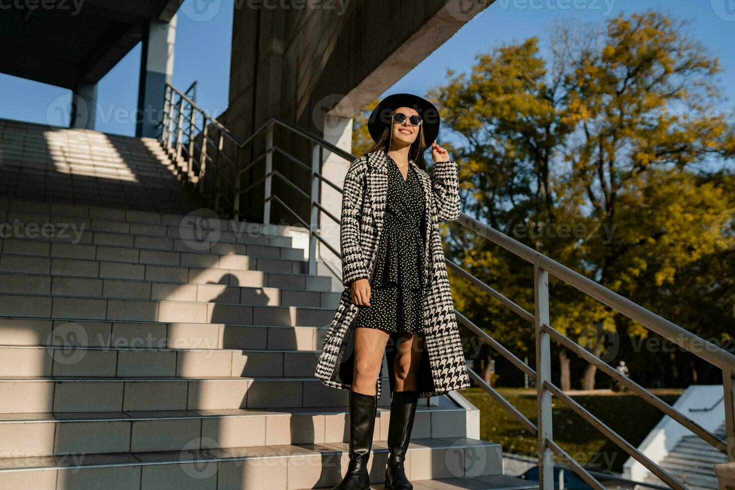 attractive young woman walking in autumn wearing coat photo