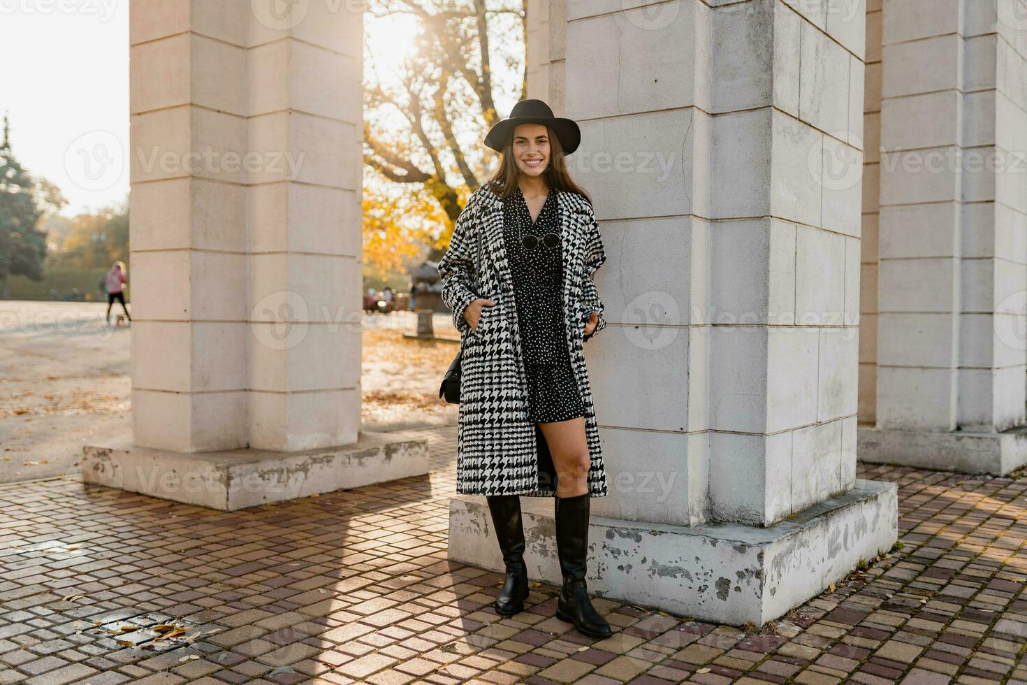 attractive young woman walking in autumn wearing coat photo