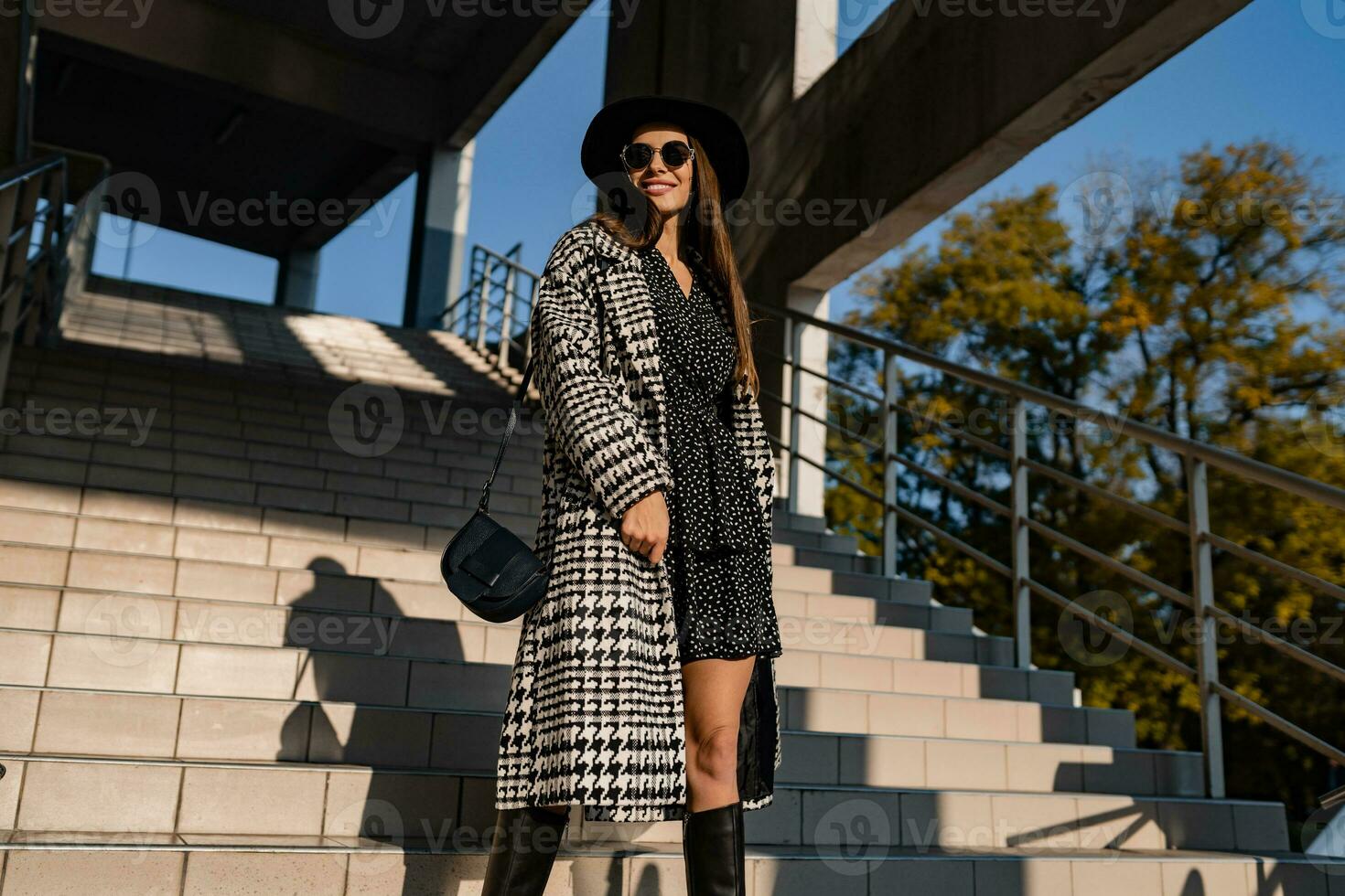 attractive young woman walking in autumn wearing coat photo