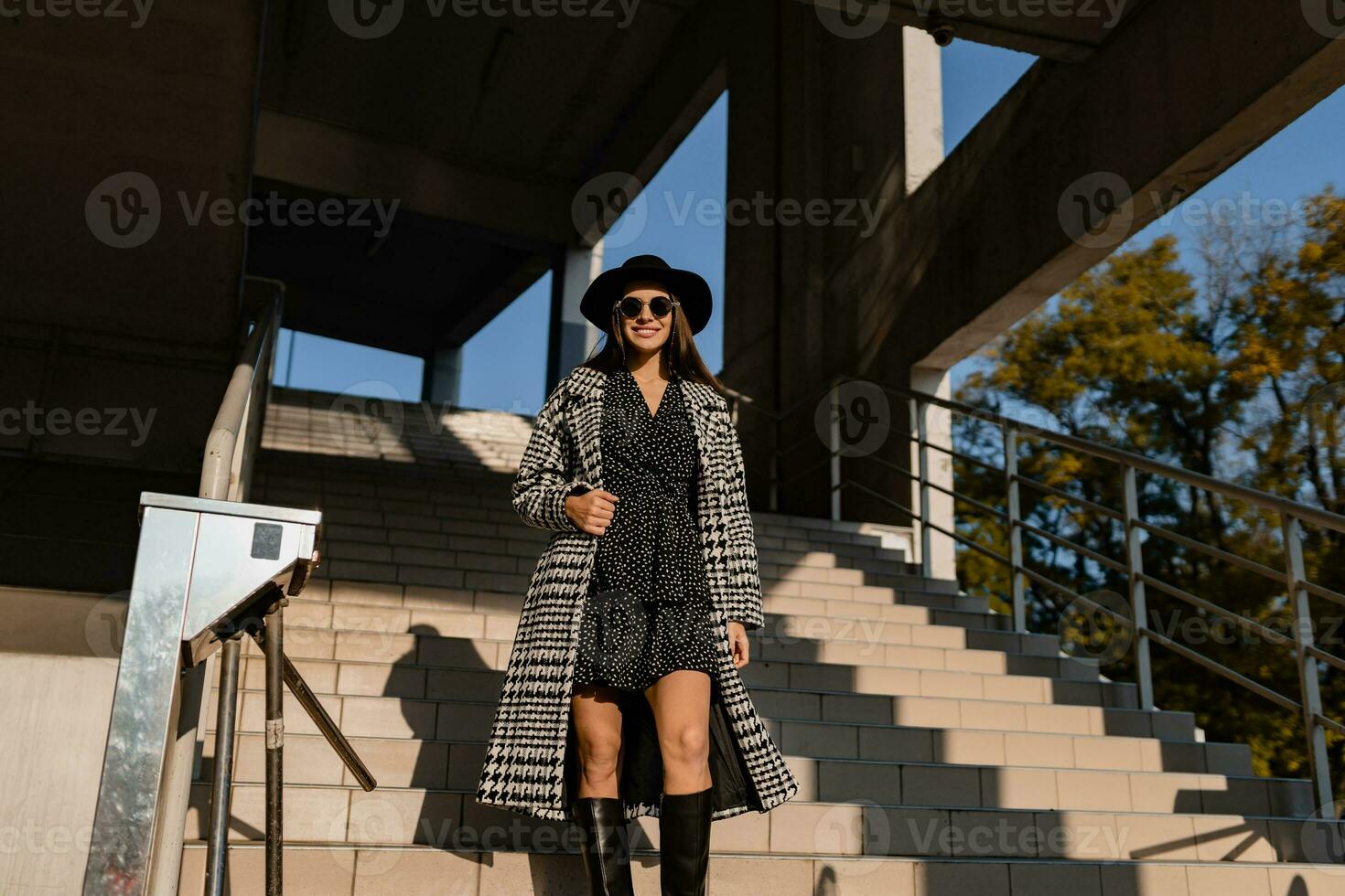 attractive young woman walking in autumn wearing coat photo