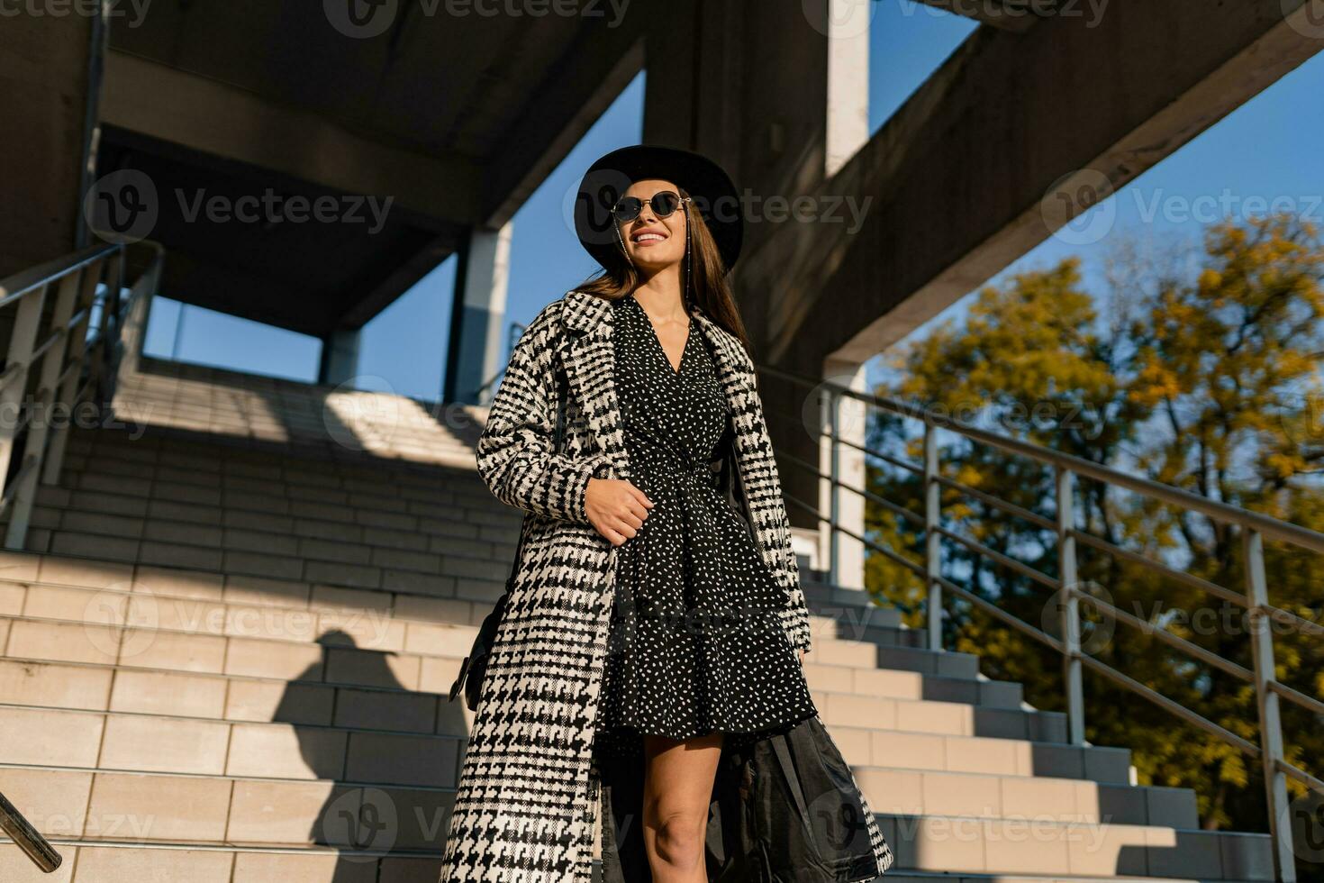 attractive young woman walking in autumn wearing coat photo