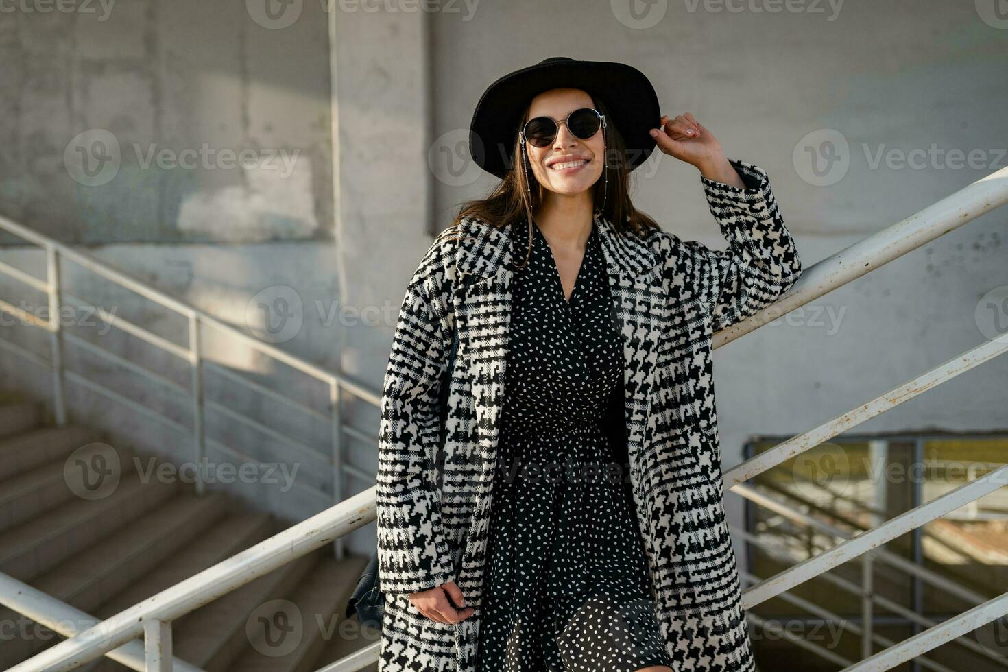 attractive young woman walking in autumn wearing coat photo