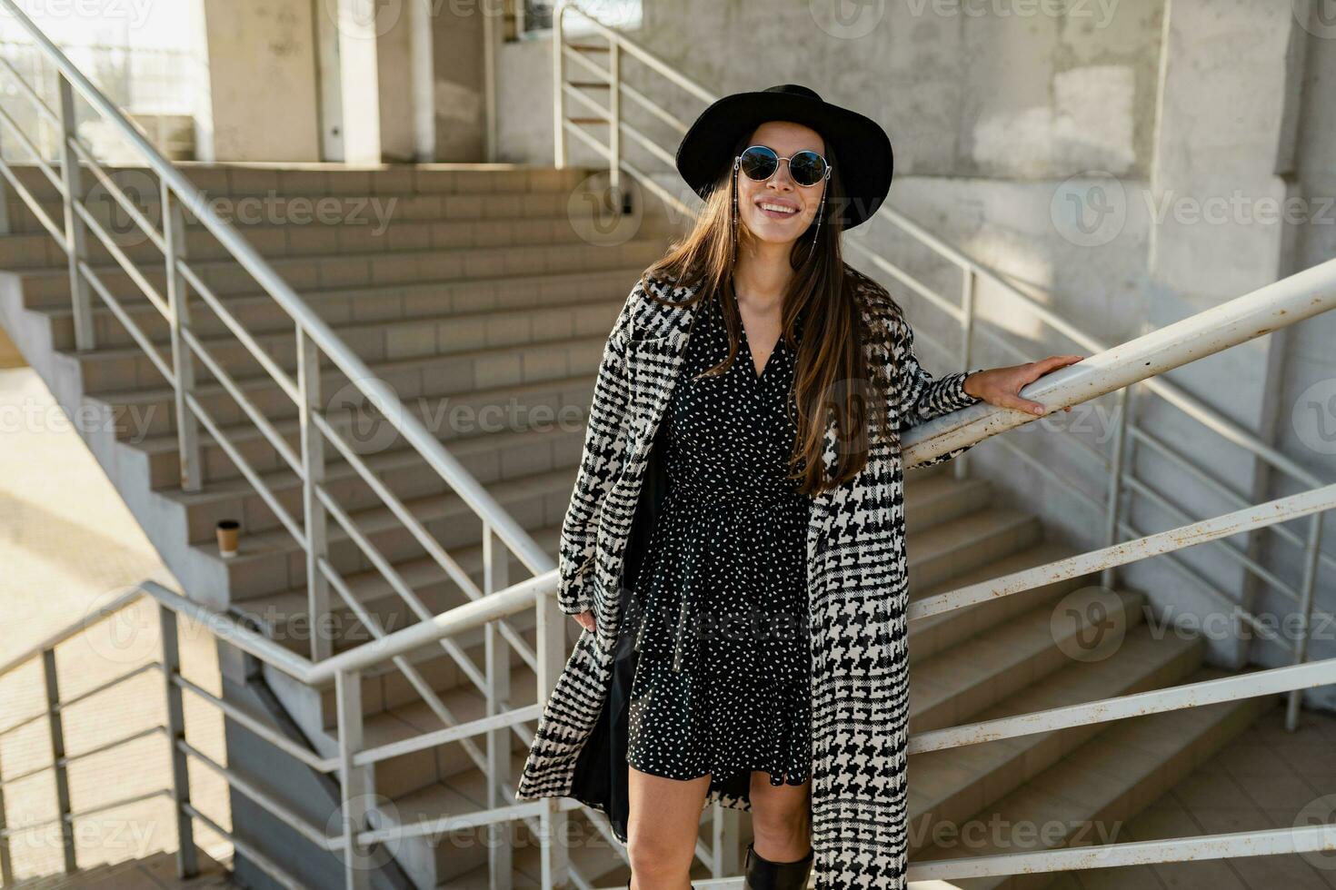 attractive young woman walking in autumn wearing coat photo