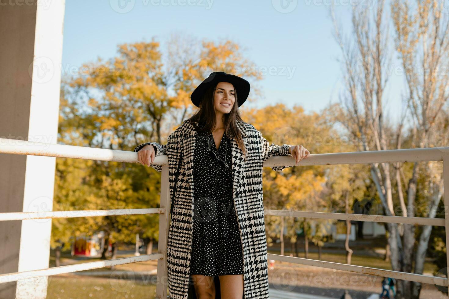 attractive young woman walking in autumn wearing coat photo