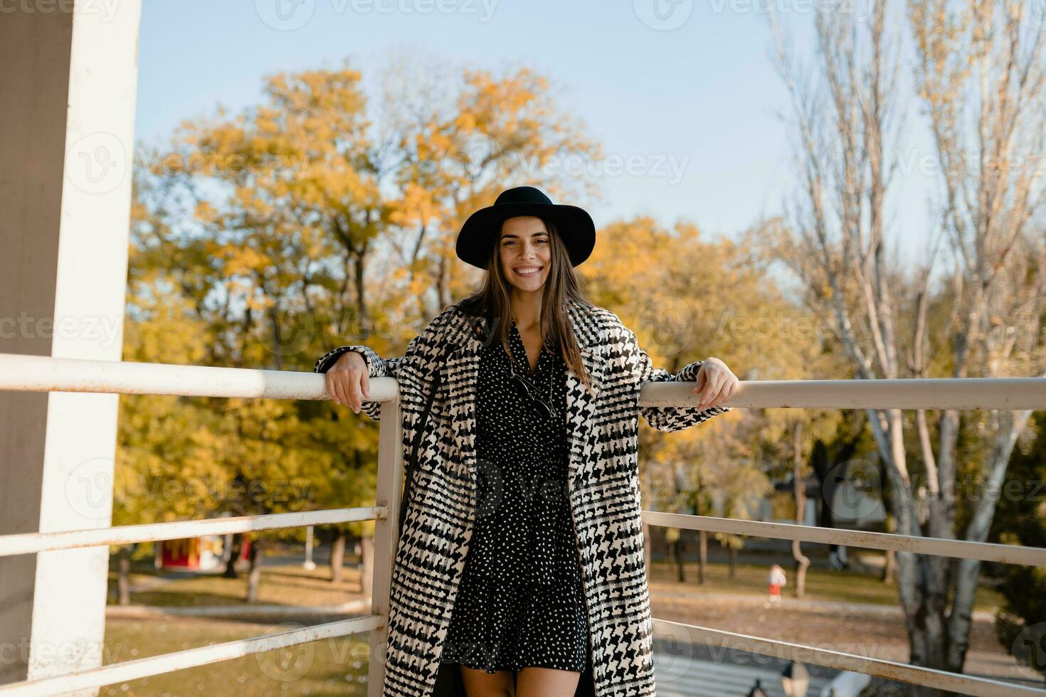 attractive young woman walking in autumn wearing coat photo