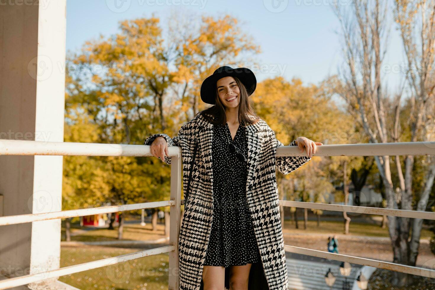 attractive young woman walking in autumn wearing coat photo