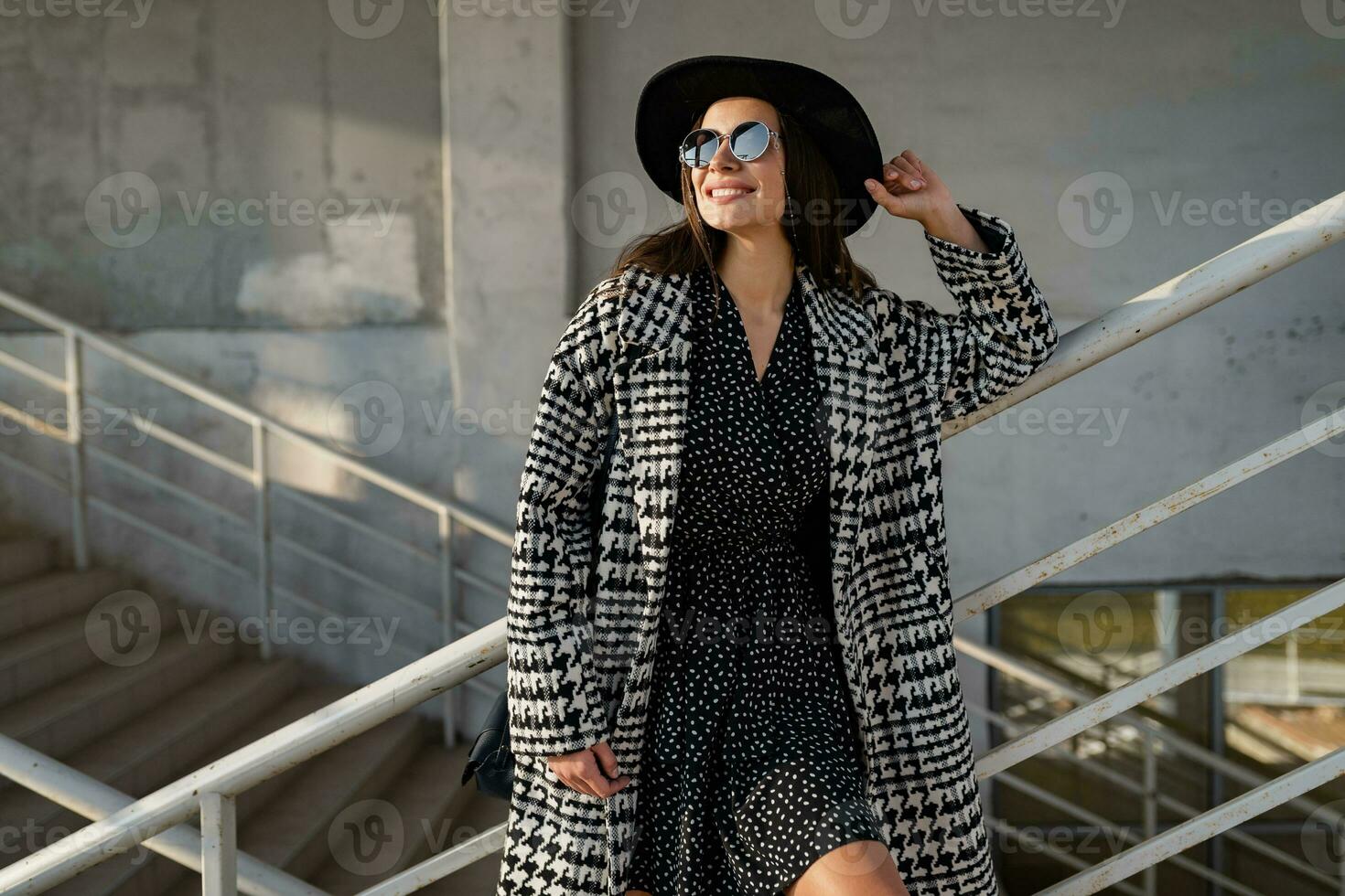 attractive young woman walking in autumn wearing coat photo
