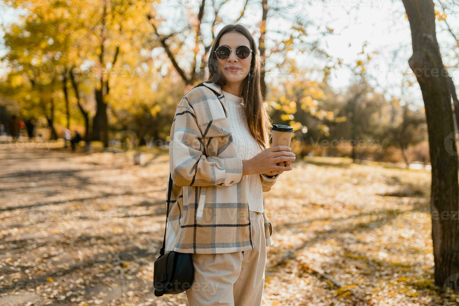 attractive young woman walking in autumn wearing jacket photo