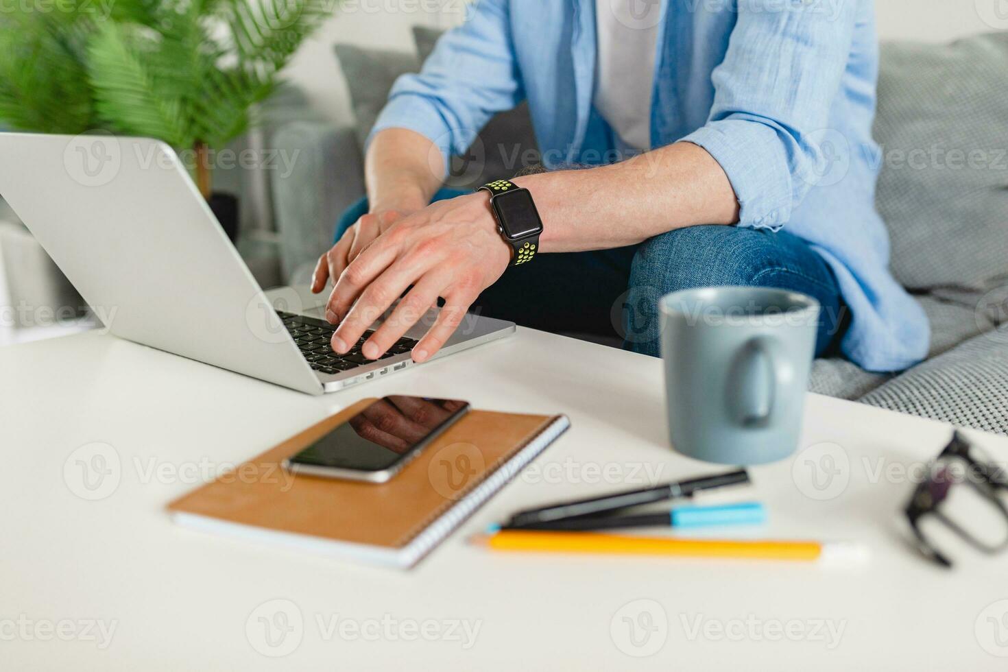 view on table workplace close-up man hands at home working typing on laptop online photo