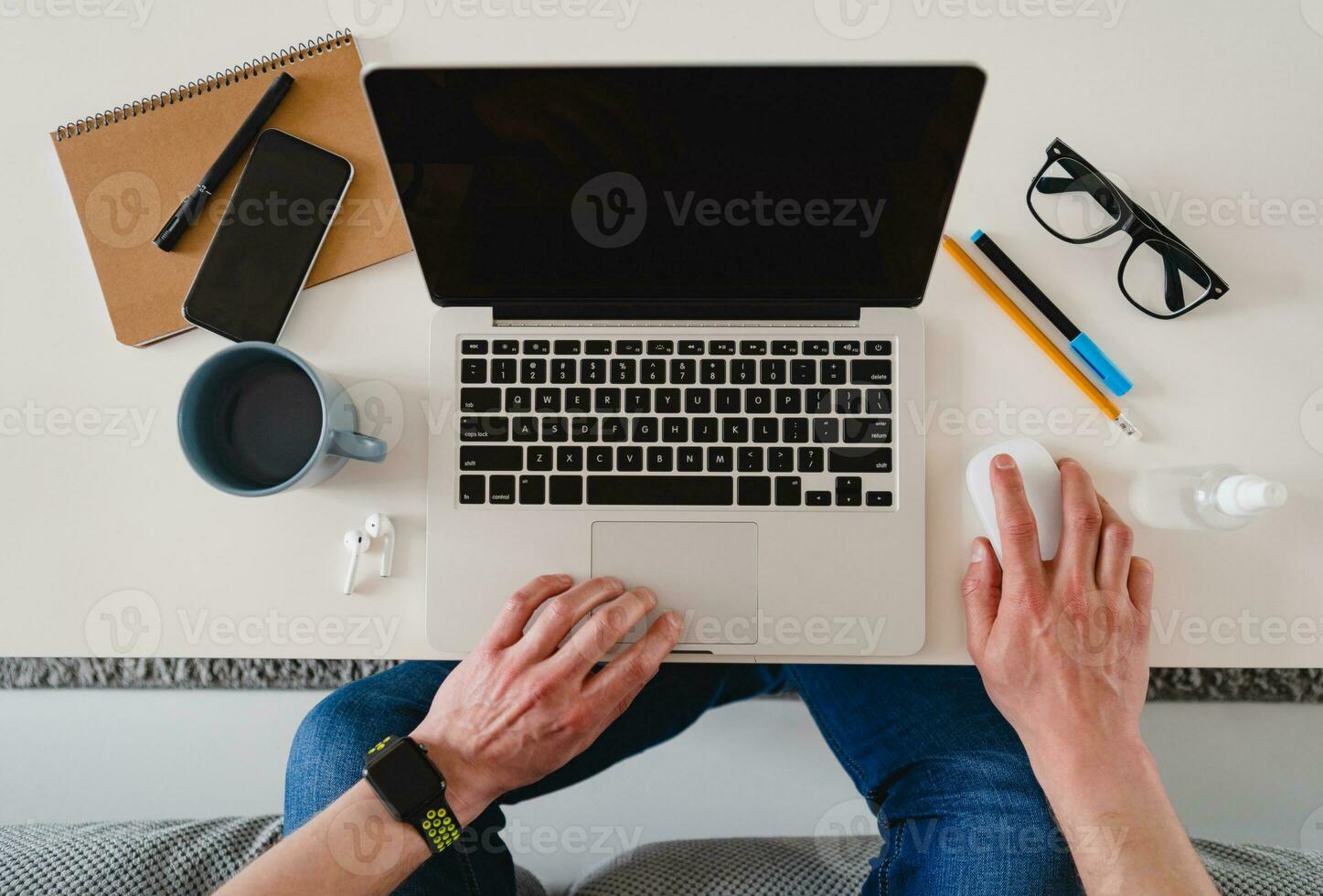 flat lay view from above on table workplace close-up man hands at home working typing on laptop photo