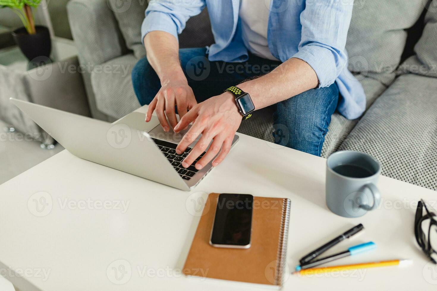 flat lay view from above on table workplace close-up man hands at home working photo