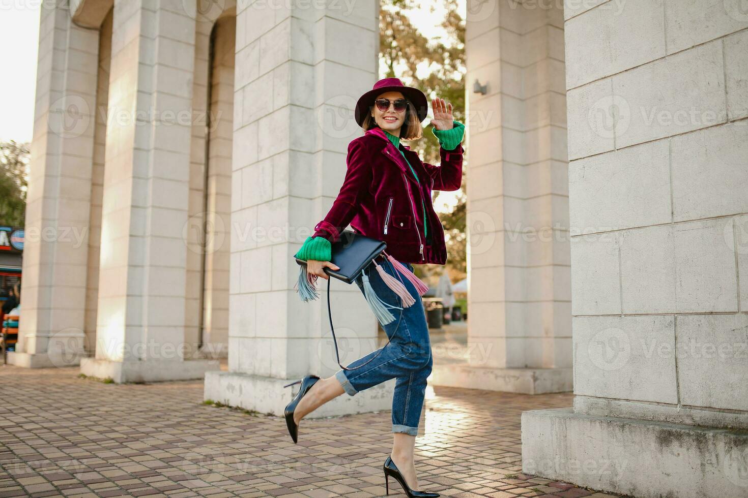 attractive woman in autumn style trendy outfit walking in street photo