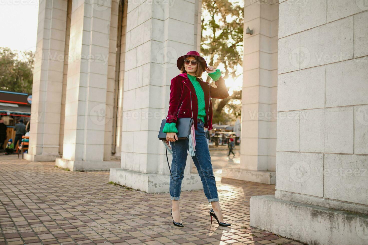 attractive woman in autumn style trendy outfit walking in street photo