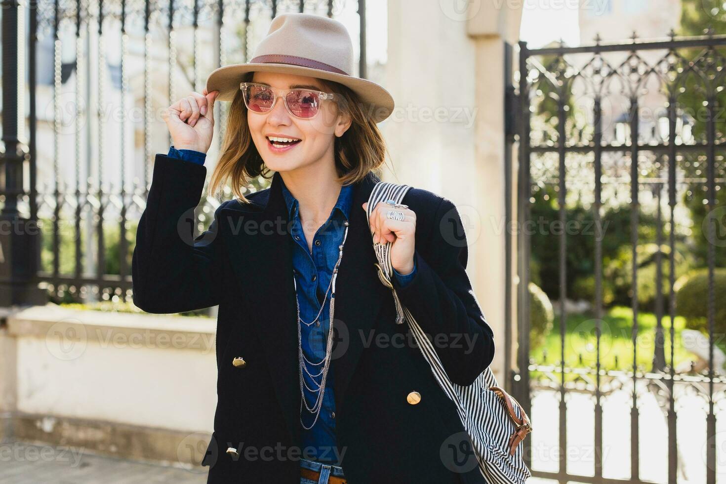 young stylish pretty woman smiling walking in city street photo
