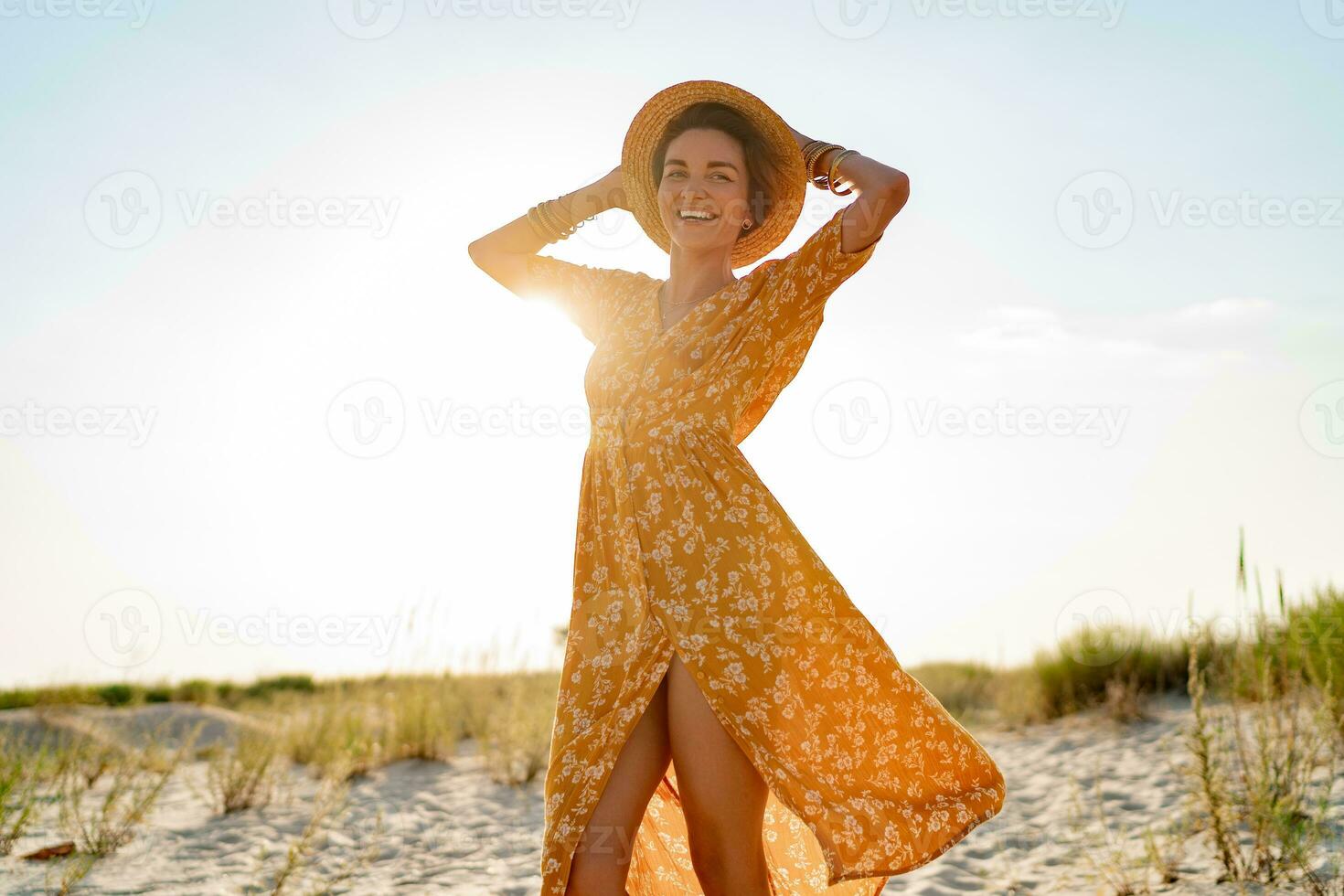 stylish attractive slim smiling woman on beach in summer style fashion trend outfit photo