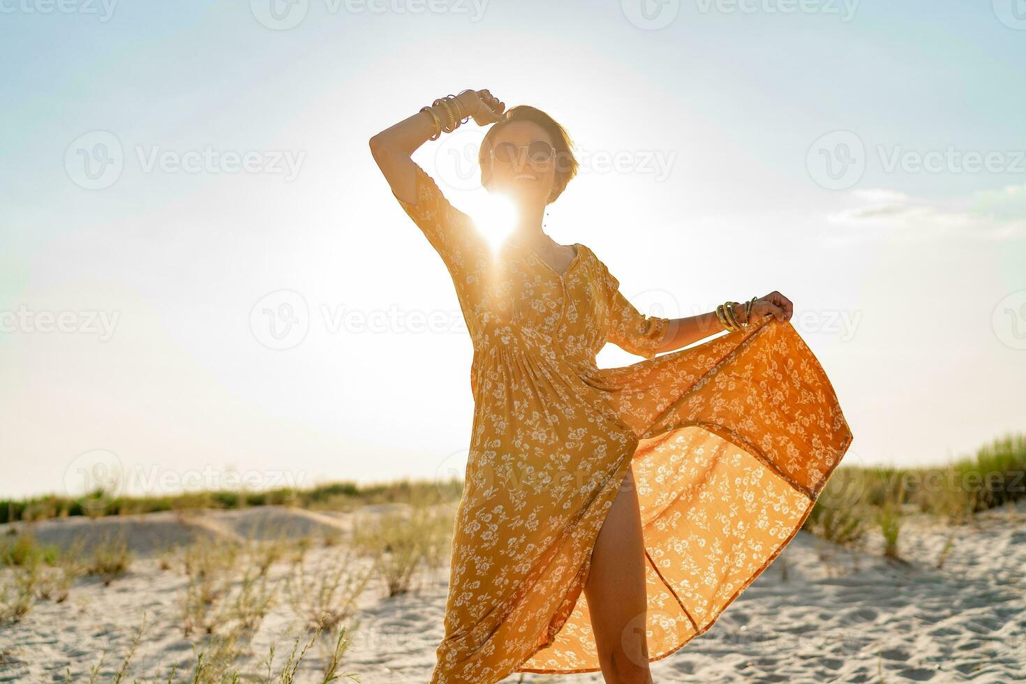 stylish attractive slim smiling woman on beach in summer style fashion trend outfit photo