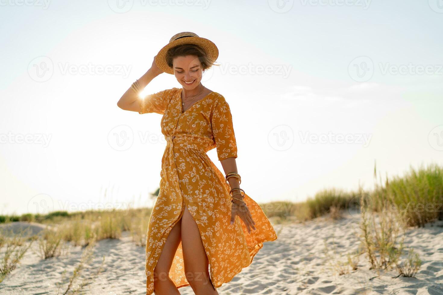 stylish attractive slim smiling woman on beach in summer style fashion trend outfit photo