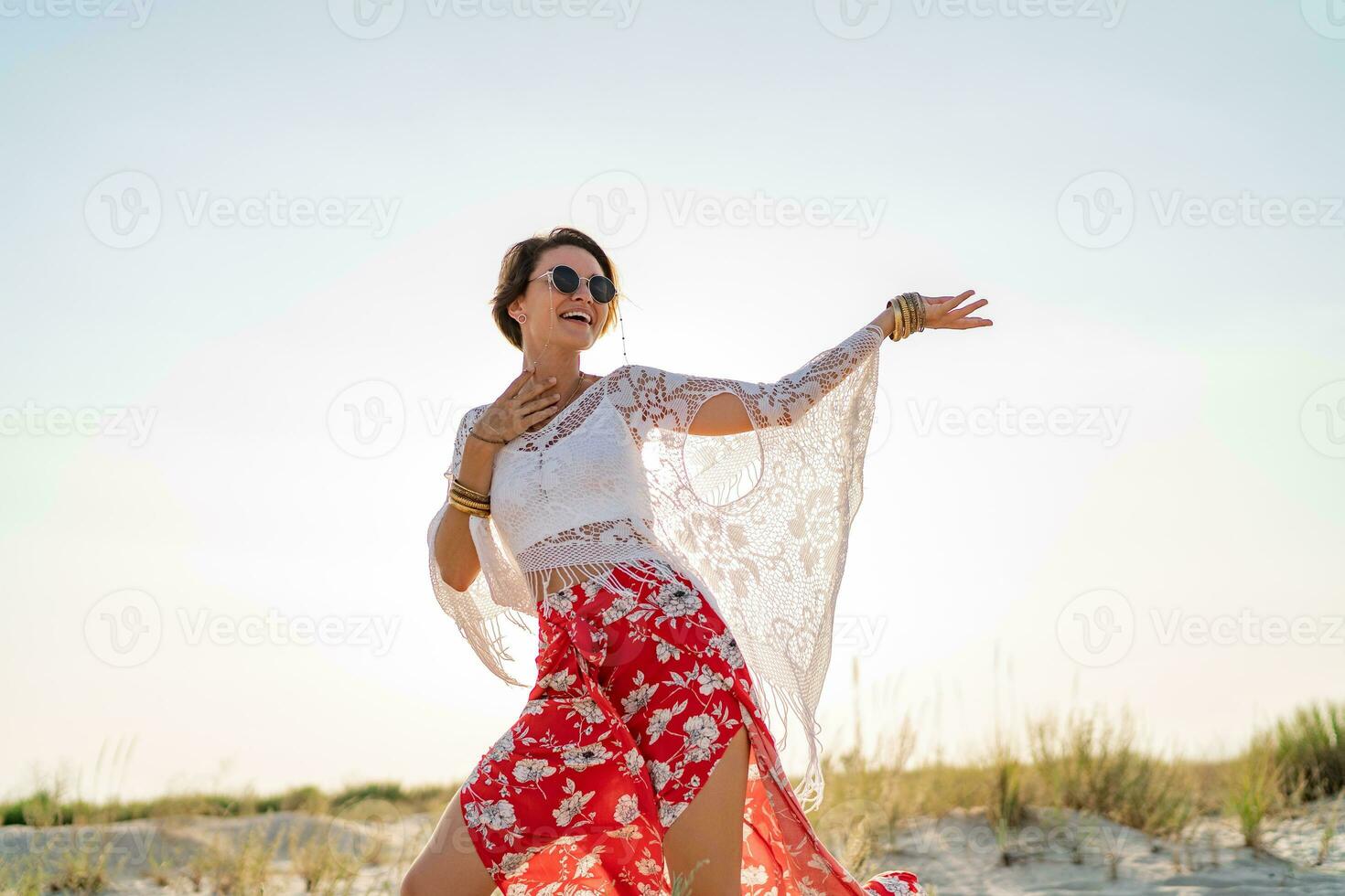 stylish attractive slim smiling woman on beach in summer style fashion trend outfit photo