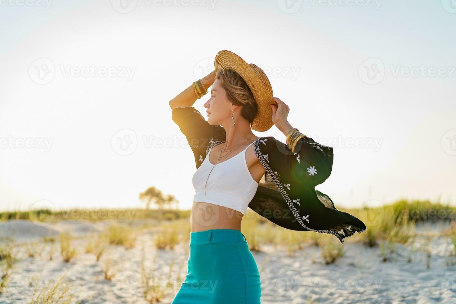 stylish attractive woman on beach in summer style fashion trend outfit happy having fun photo