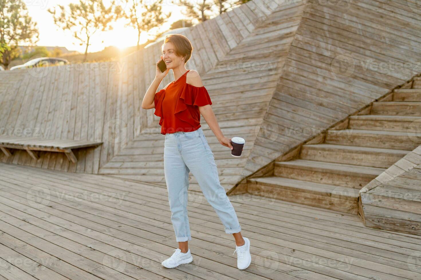 young pretty woman having good time in modern park street photo
