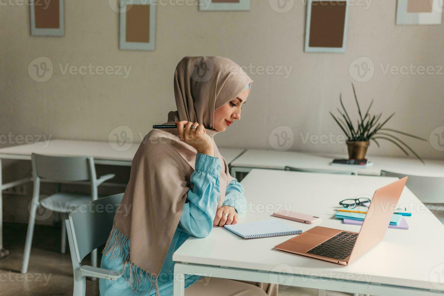 modern muslim woman in hijab in office room photo