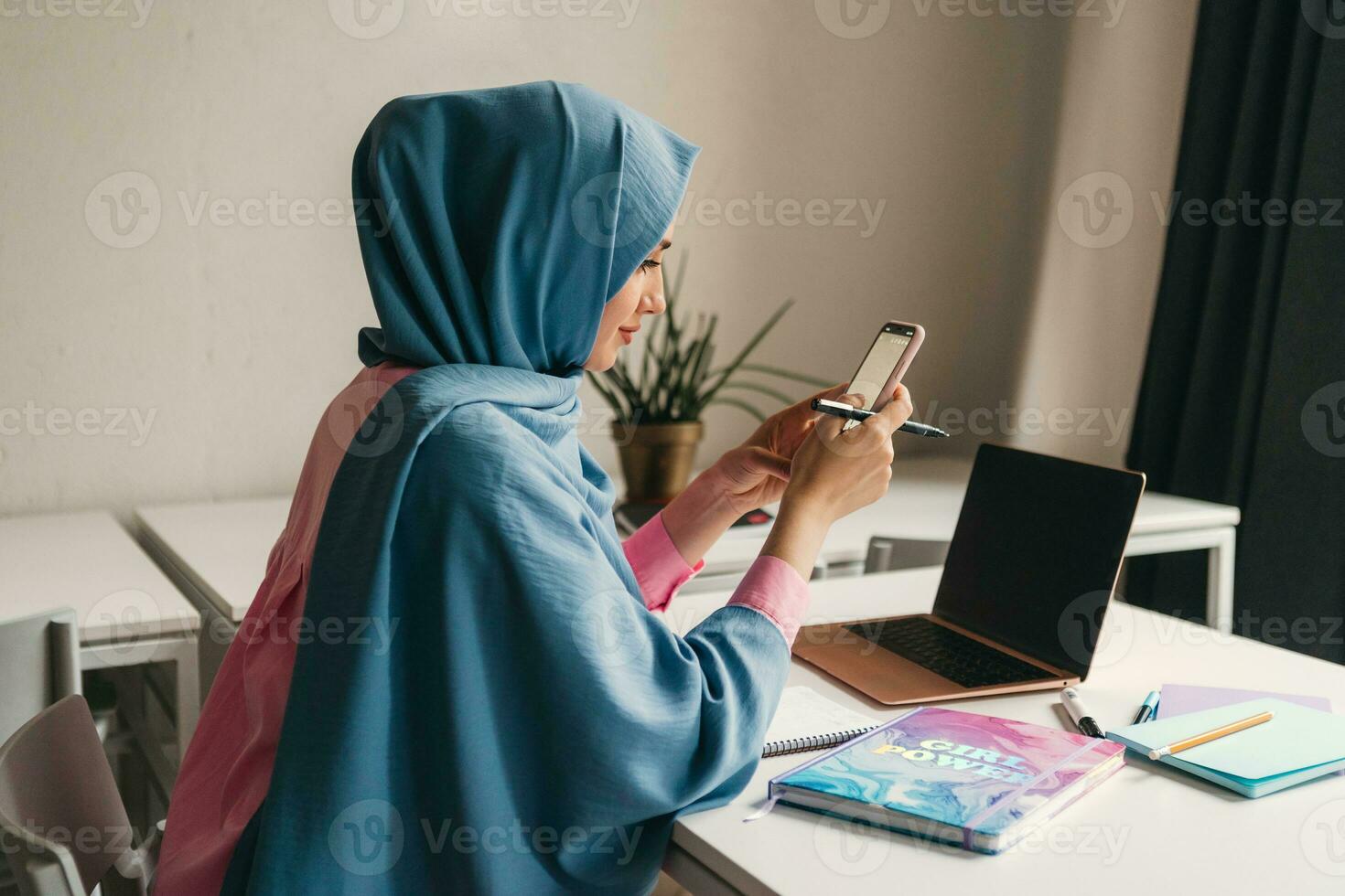 modern muslim woman in hijab in office room photo