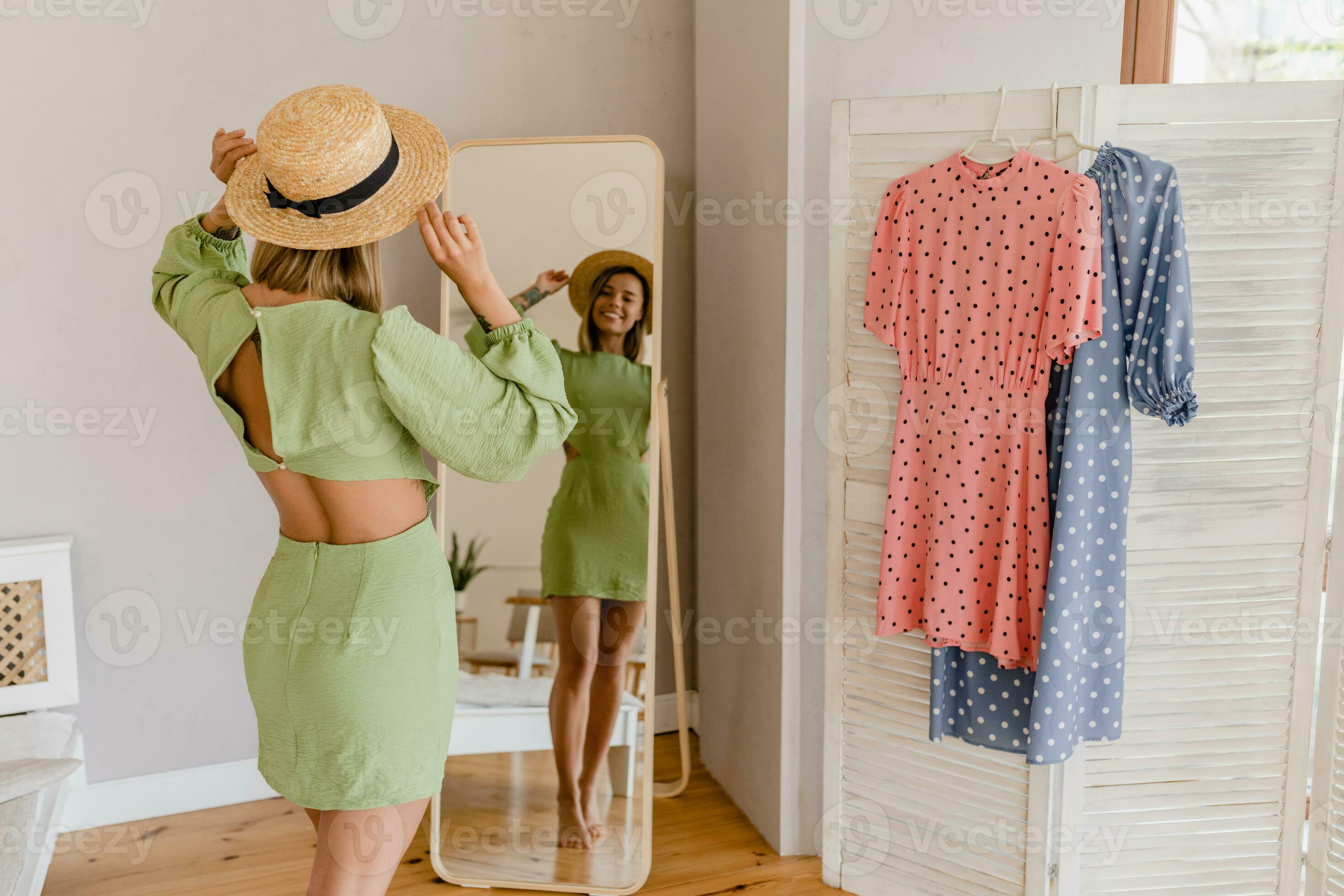 young pretty woman in green dress trying on style trend dress looking