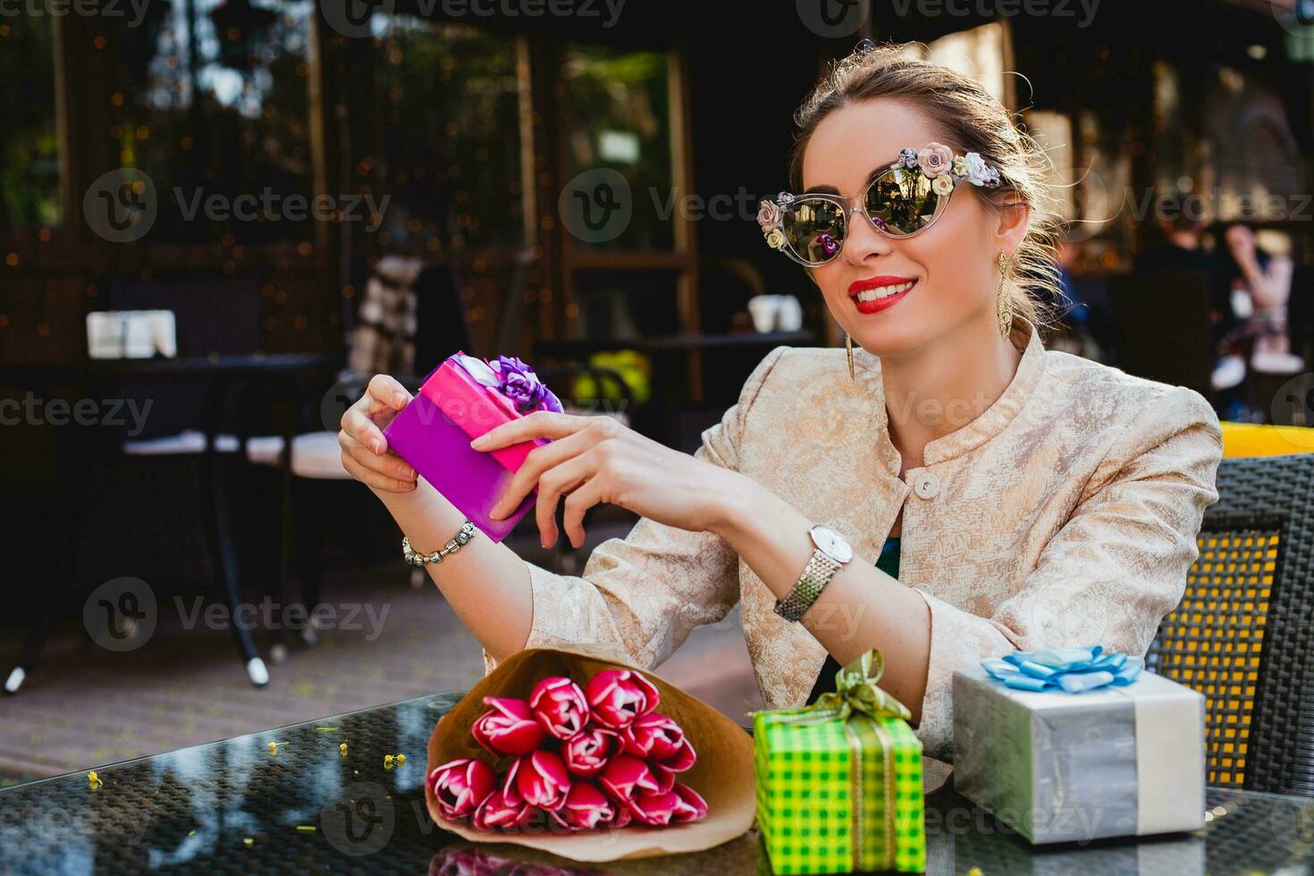 young stylish beautiful woman in fashion sunglasses sitting at cafe photo