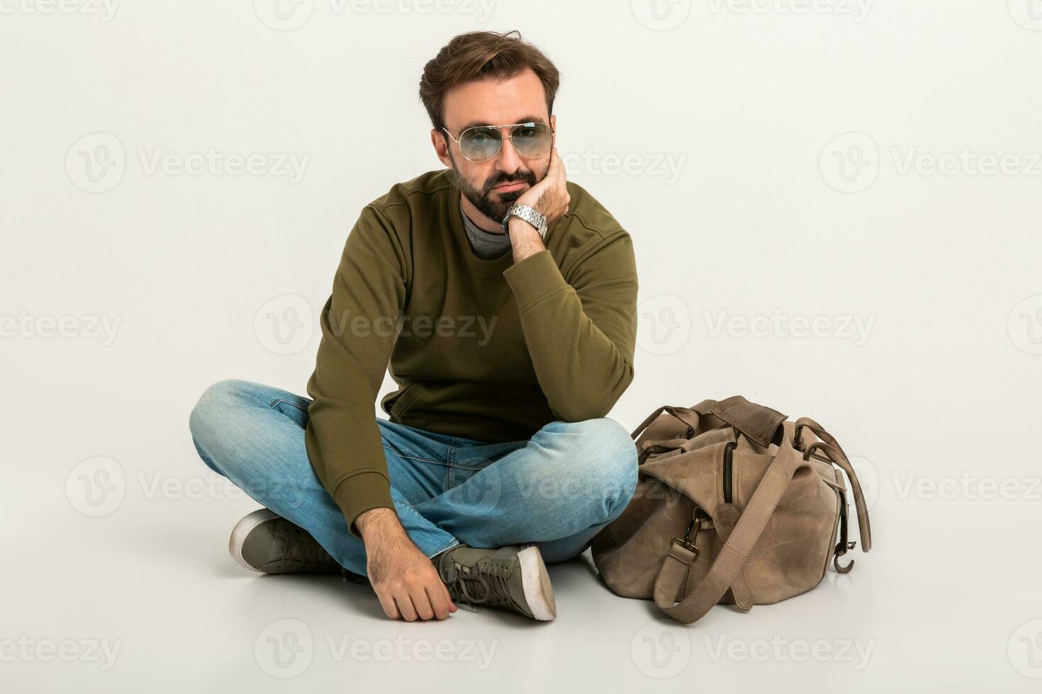 hansome bearded stylish man sitting on floor photo