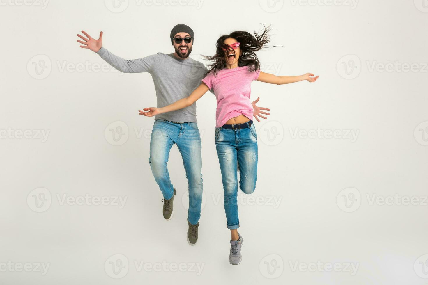 hipster stylish couple jumping pretty smiling emotional woman and man photo
