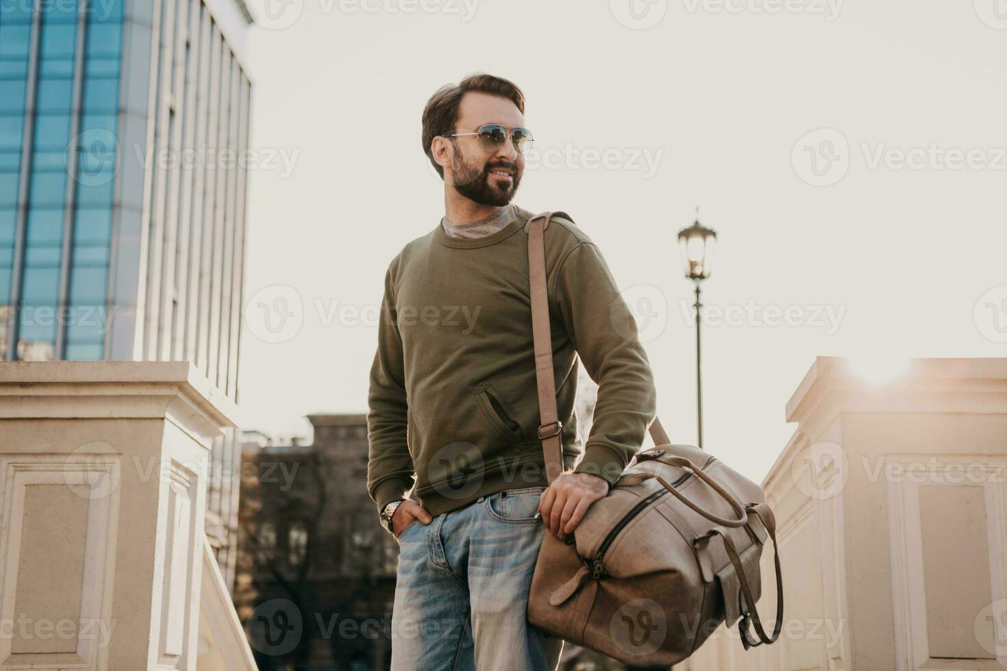 hipster man walking in street with bag photo