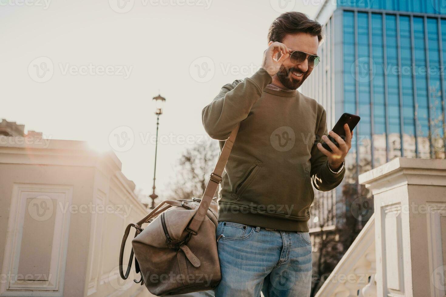 hipster man walking in street with bag photo