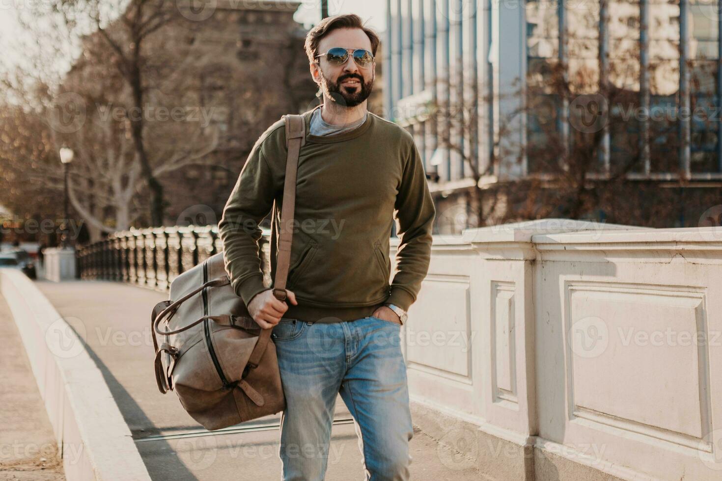 hipster man walking in street with bag photo