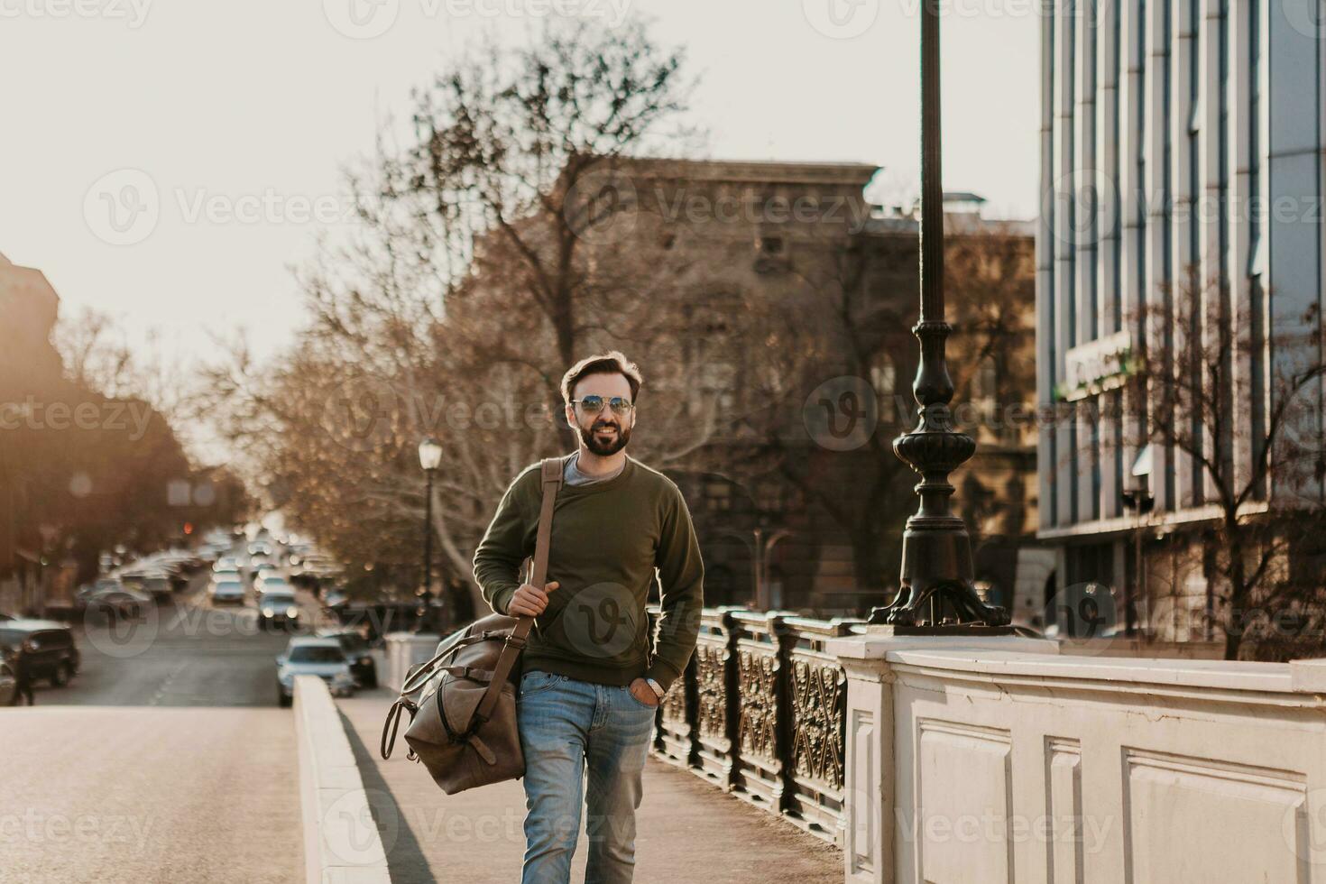 hipster man walking in street with bag photo