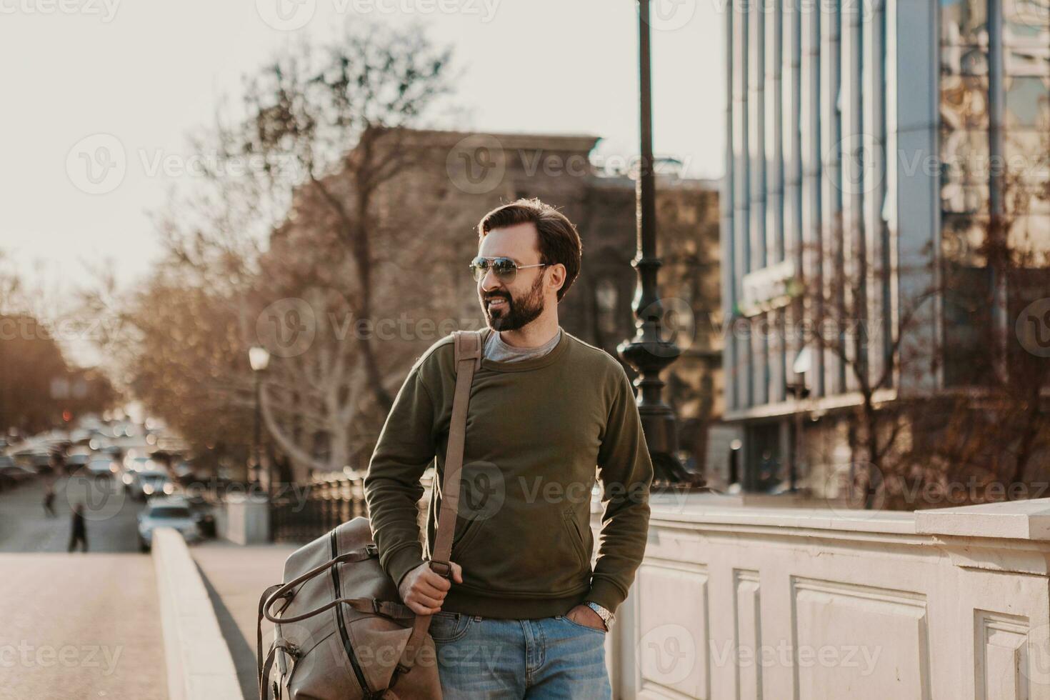 hipster man walking in street with bag photo