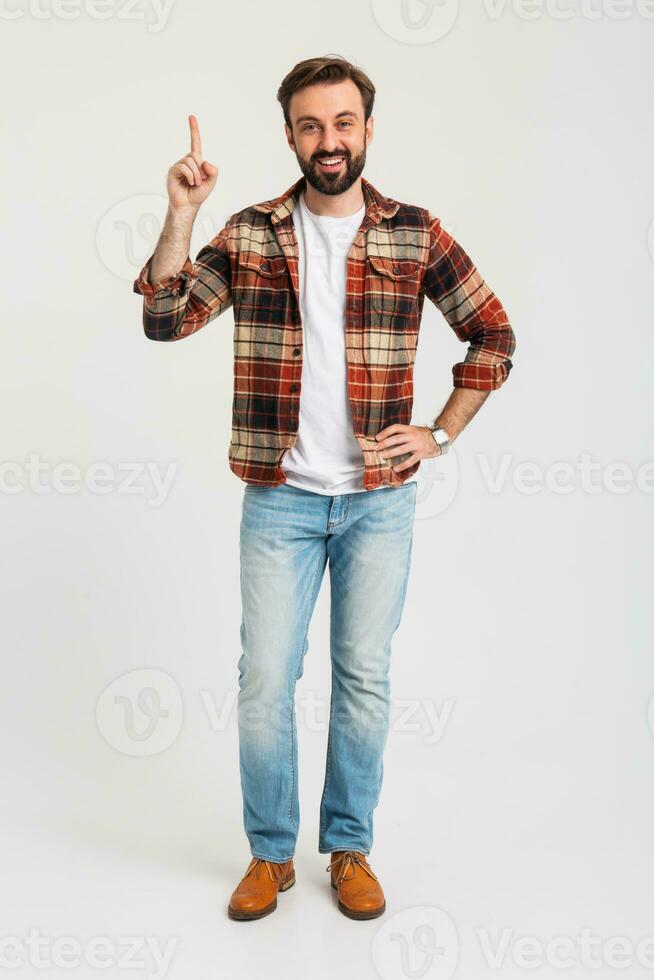 handsome bearded man in hipster outfit dressed in jeans and checkered shirt photo