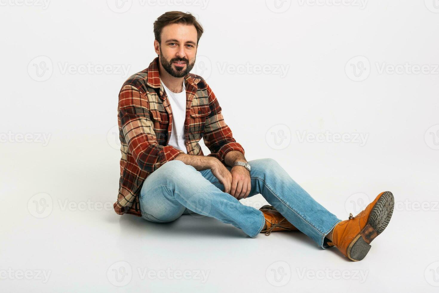 handsome bearded man in hipster outfit dressed in jeans and checkered shirt photo