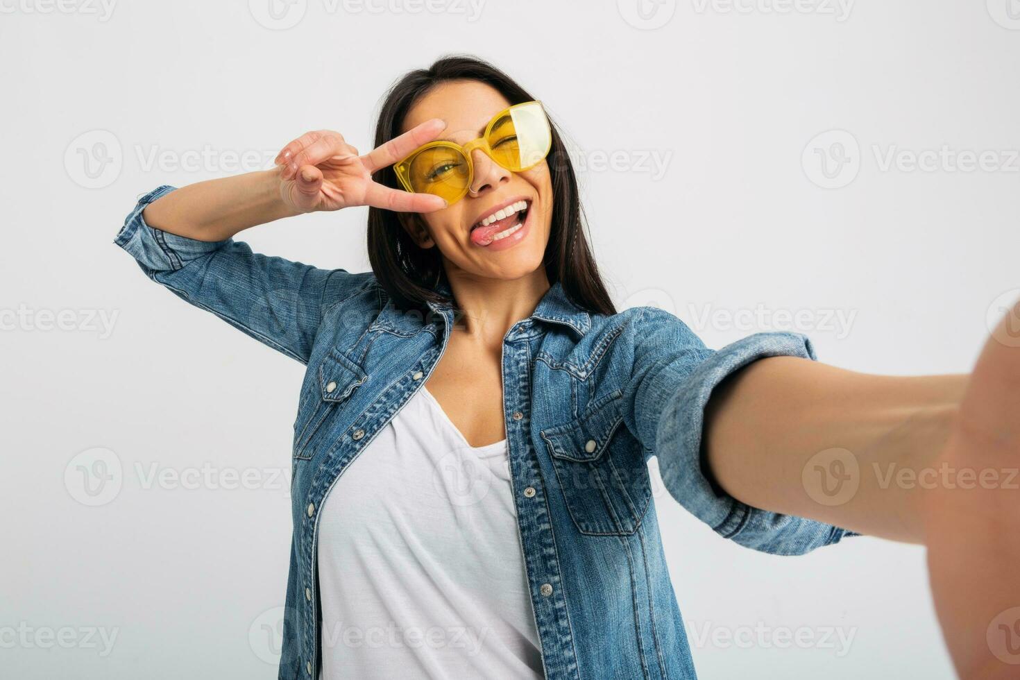 attractive woman dressed jeans and denim shirt wearing yellow sunglasses photo