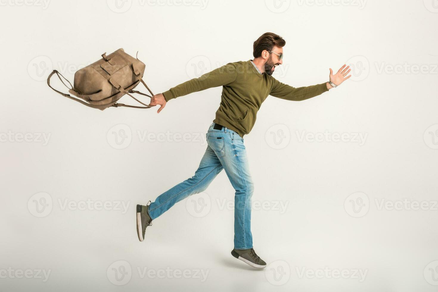 handsome bearded stylish man jumping running photo