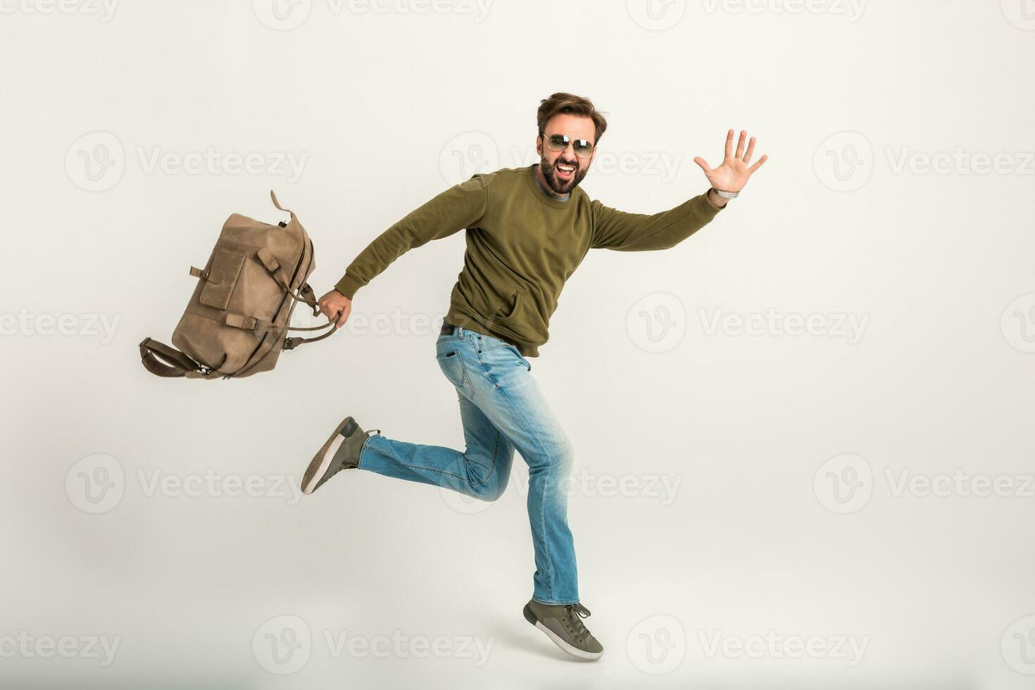 handsome bearded stylish man jumping running photo