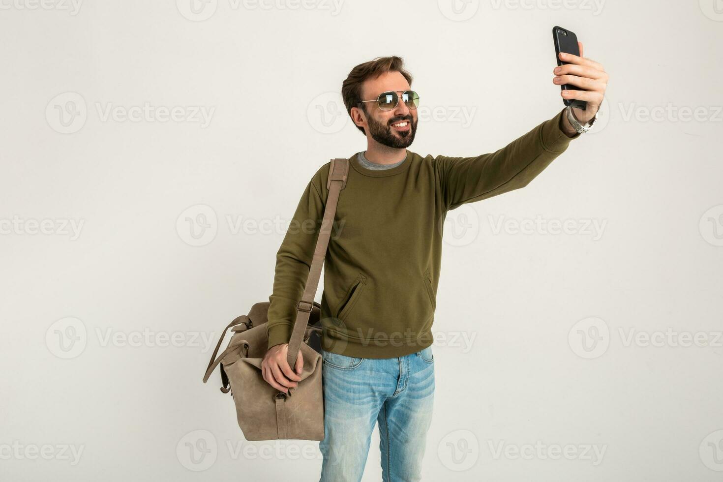attractive stylish man traveler standing with bag photo